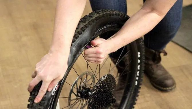 Put Pressure On Both Sides Of The Tire To Seal It Onto The Rim.